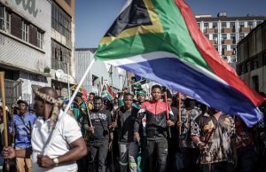 Xenophobia: FG Urges South Africa To Take Concrete Action Against Attacks On Nigerians Protesters hold sticks and flags while chanting slogans as they march during a demonstration by the "March and March" and Operation Dudula movements marking an unofficial deadline set by citizen-led groups for undocumented foreign nationals to leave South Africa, in Johannesburg, on June 30, 2026. South African police deployed to head off unrest and protests on June 30, 2026, the unofficial deadline set by anti-immigrant groups for undocumented foreign nationals to leave that has already pushed thousands to flee. Officers were out in force to prevent violence and looting by the xenophobic groups, while hundreds of foreign nationals took refuge in several cities, urgently seeking help to leave. (Photo by EMMANUEL CROSET / AFP)