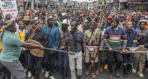 FG to seek compensation for returning Nigerians from South Africa – Envoy Members of the Zulu regiment known as the ‘Amabutho’ chant slogans as they march during a demonstration by the "March and March" movement marking an unofficial deadline set by citizen-led groups for undocumented foreign nationals to leave South Africa, in Durban, on June 30, 2026. Thousands of demonstrators massed across South African cities on June 30, 2026, venting anger at undocumented foreign nationals as police mounted a major operation to head off looting and xenophobic violence that has claimed four lives. The nationwide protests cap weeks of demonstrations called by a loose coalition of minor political parties and small citizen-led vigilante groups, which set an unofficial June 30 deadline for foreigners without residency papers to leave. (Photo by RAJESH JANTILAL / AFP)