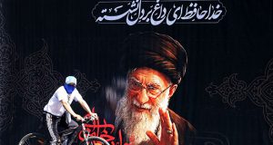 Supreme Leader’s Body Arrives At Tehran Religious Complex For Funeral billboard-featuring-a-portrait-of-Irans-slain-supreme-leader-Ali-Khamenei