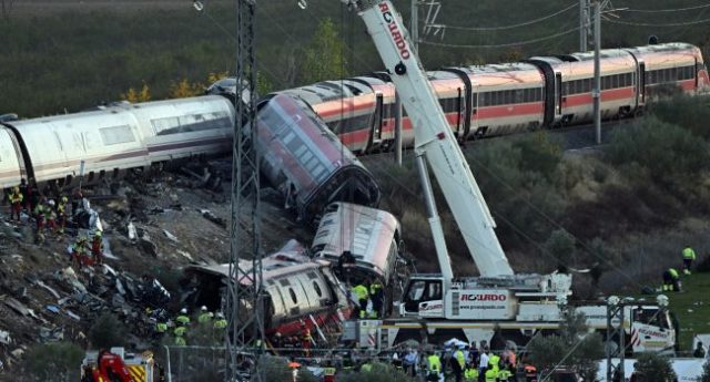A-truck-crane-is-operated-at-the-site-of-a-train-crash-between-two-high-speed-units-a-Renfe-AVE-tra A-truck-crane-is-operated-at-the-site-of-a-train-crash-between-two-high-speed-units-a-Renfe-AVE-tra