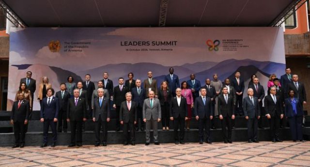 Attendees-pose-for-a-family-photo-during-the-leaders-summit-of-the-17th-meeting-of-the-Conference-o Attendees-pose-for-a-family-photo-during-the-leaders-summit-of-the-17th-meeting-of-the-Conference-o